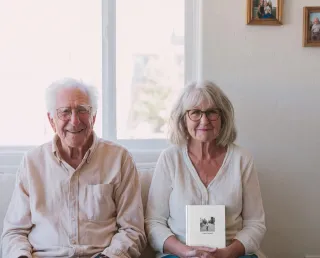 A couple holding their hardcover Ethos book