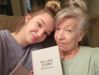 A grandmother and granddaughter with their Ethos book