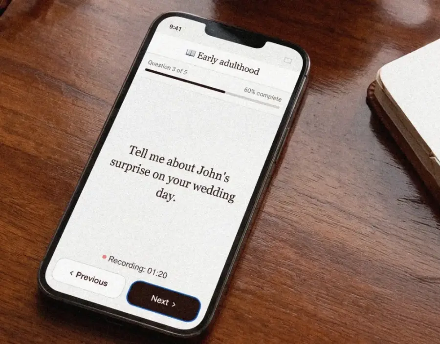 A phone on a table showing this week's question, with a recording timer running under it